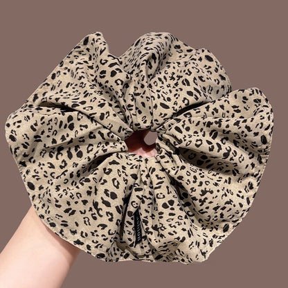 A leopard print scrunchy set with 6pcs of scrunchies, with different sizes and colors.