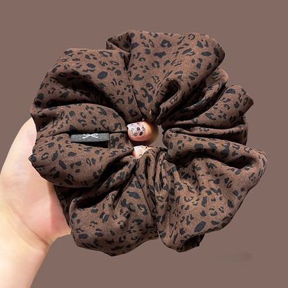 A leopard print scrunchy set with 6pcs of scrunchies, with different sizes and colors.