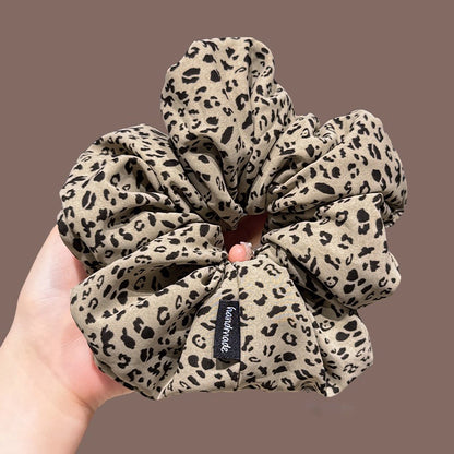 A leopard print scrunchy set with 6pcs of scrunchies, with different sizes and colors.