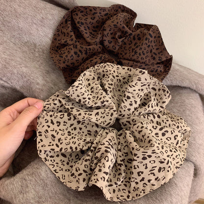 A leopard print scrunchy set with 6pcs of scrunchies, with different sizes and colors.