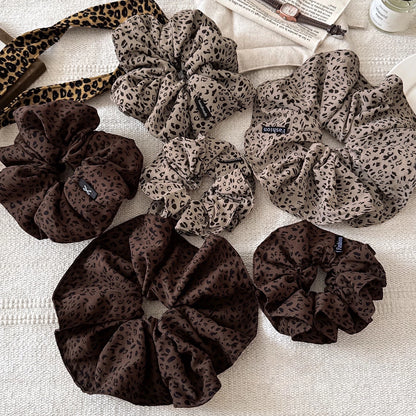 A leopard print scrunchy set with 6pcs of scrunchies, with different sizes and colors.