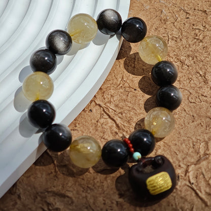 This is a silver sheen obsidian and rutilated quartz bracelet, finished with aloeswood and south red agate pendant—luxury forged in primal power.