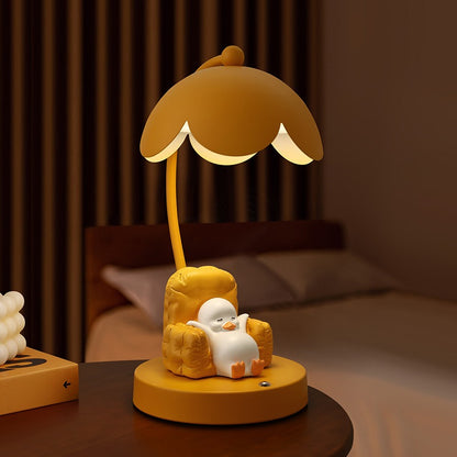 This is a bedside lamp with a design of a duck lying in a yellow sofa. And it comes with a round lampshade. Smooth rounded lines and artistic detailing make it a decorative bedside lamp and a comforting companion after long workdays.