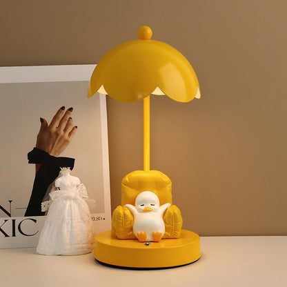 This is a bedside lamp with a design of a duck lying in a yellow sofa. And it comes with a round lampshade. Smooth rounded lines and artistic detailing make it a decorative bedside lamp and a comforting companion after long workdays.