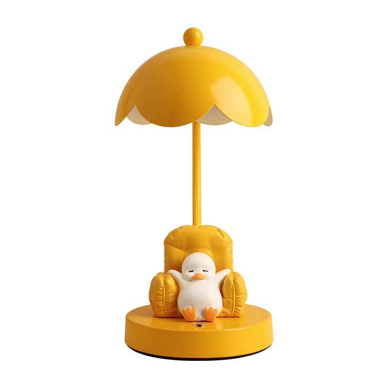 This is a bedside lamp with a design of a duck lying in a yellow sofa. And it comes with a round lampshade. Smooth rounded lines and artistic detailing make it a decorative bedside lamp and a comforting companion after long workdays.