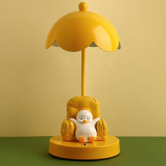This is a bedside lamp with a design of a duck lying in a yellow sofa. And it comes with a round lampshade. Smooth rounded lines and artistic detailing make it a decorative bedside lamp and a comforting companion after long workdays.