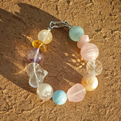 A macaron-hued bracelet spun from aquamarine, rose quartz, clear quartz, citrine, and amethyst.