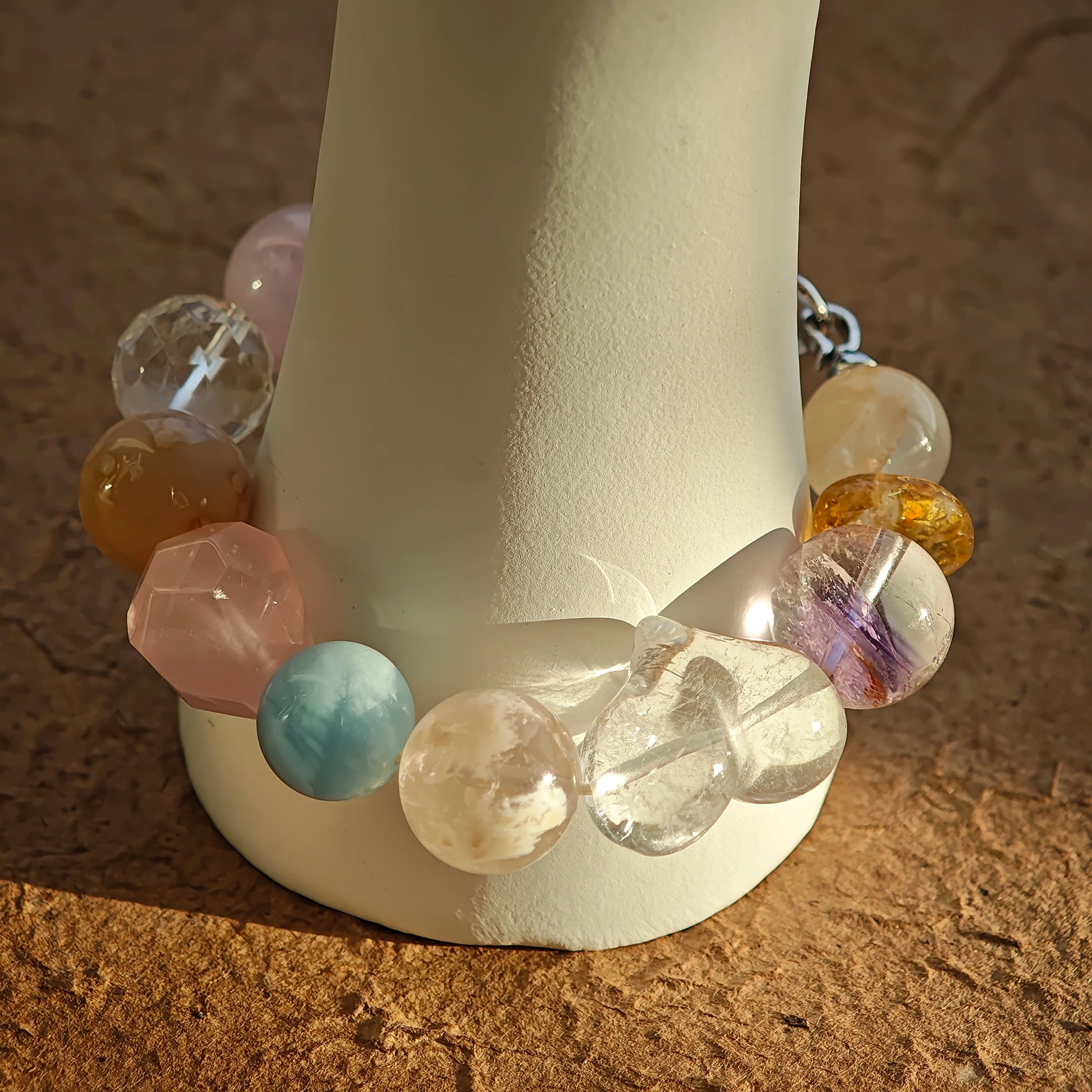 Soft, sugary hues unite aquamarine, rose quartz, clear quartz, citrine, and amethyst on your wrist.