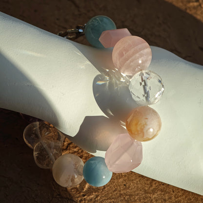 A gentle rainbow of aquamarine, rose quartz, clear quartz, citrine, and amethyst dresses your wrist.