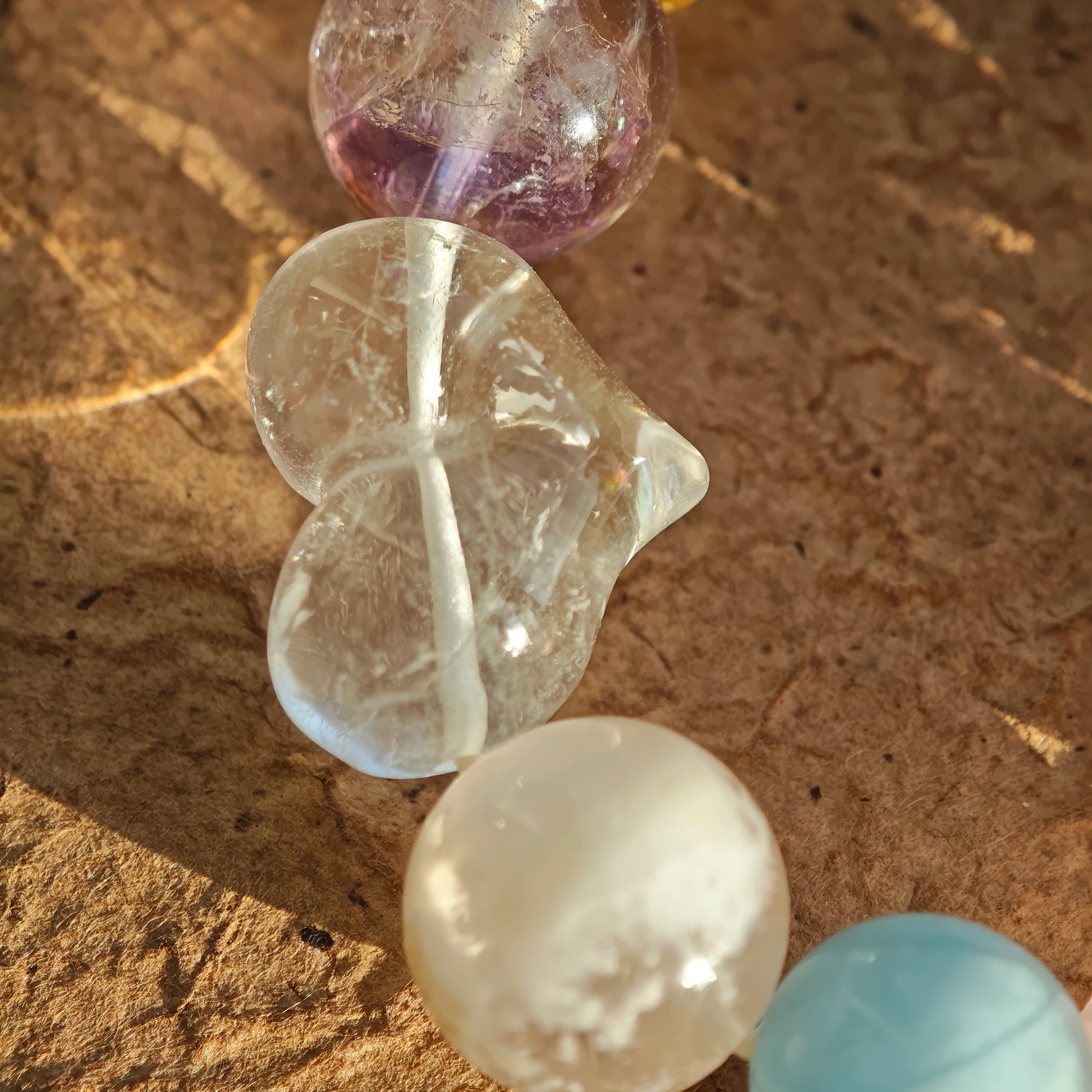 This crystal stack layers aquamarine, rose quartz, clear quartz, citrine, and amethyst like sugary macarons.
