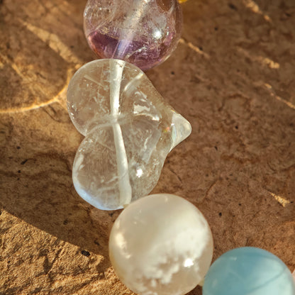 This crystal stack layers aquamarine, rose quartz, clear quartz, citrine, and amethyst like sugary macarons.
