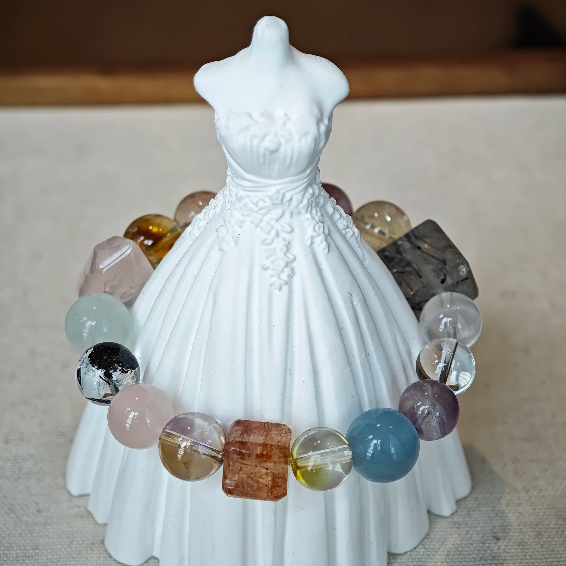 This multi gemstone bracelet features aquamarine, amethyst, strawberry quartz, rose quartz, green phantom quartz, and black rutilated quartz.