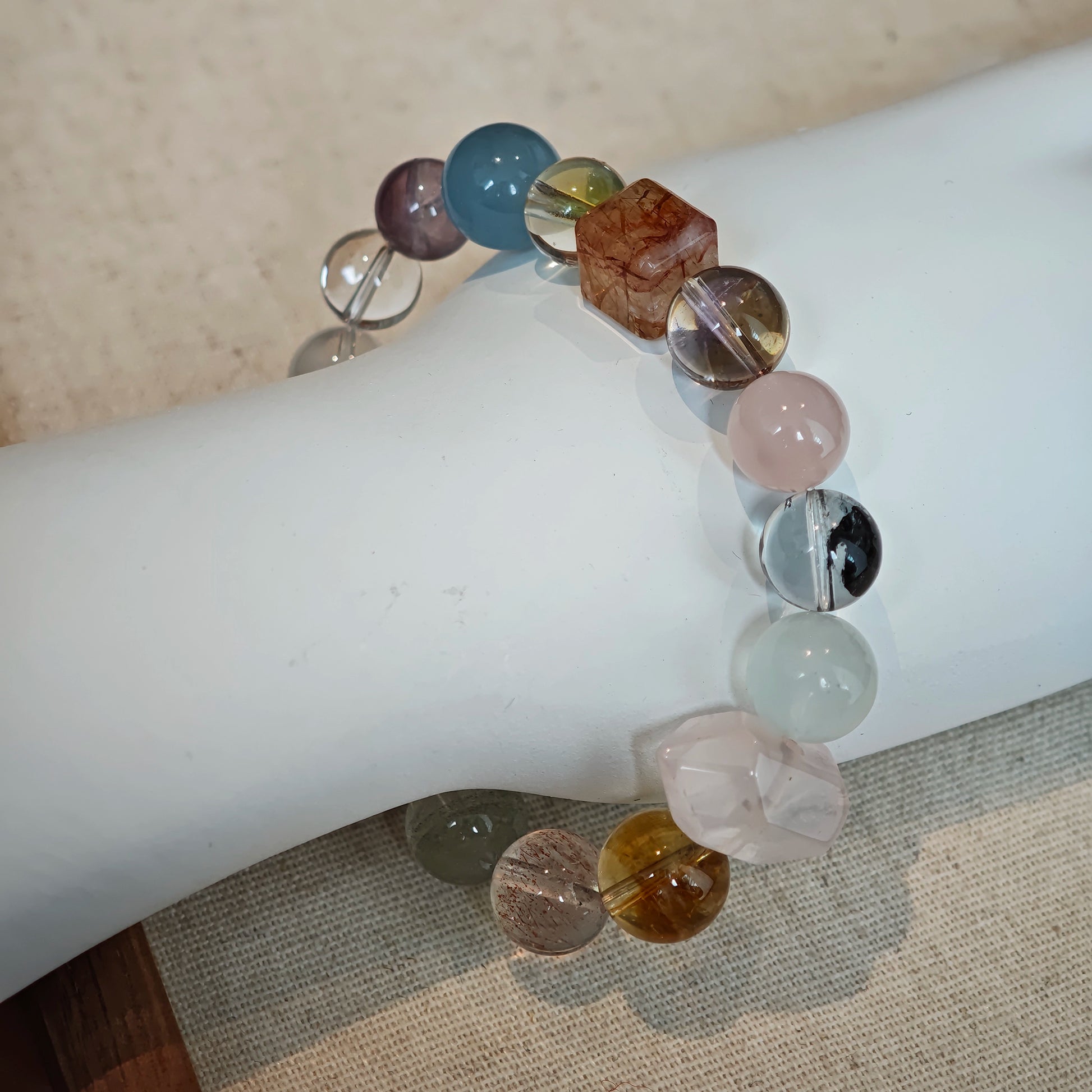 This multi gemstone bracelet features aquamarine, amethyst, strawberry quartz, rose quartz, green phantom quartz, and black rutilated quartz.