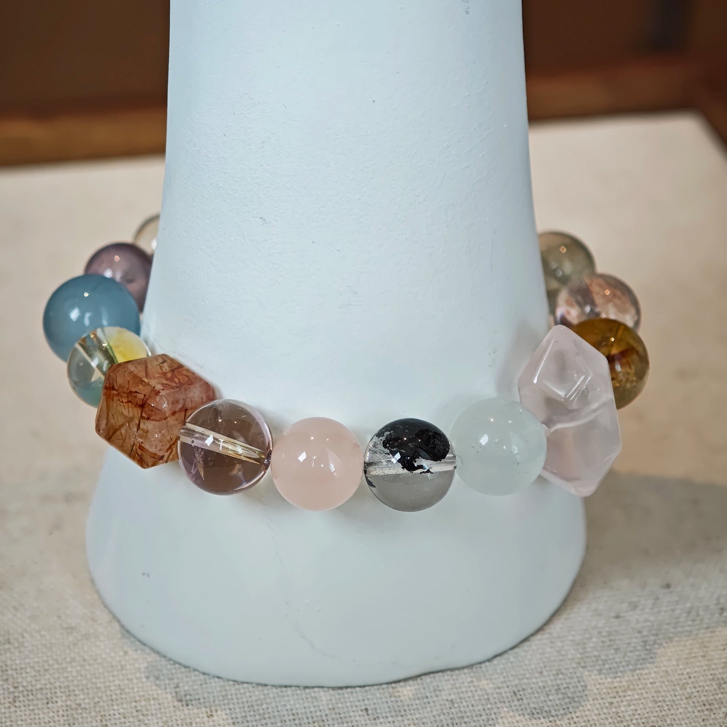 This multi gemstone bracelet features aquamarine, amethyst, strawberry quartz, rose quartz, green phantom quartz, and black rutilated quartz.