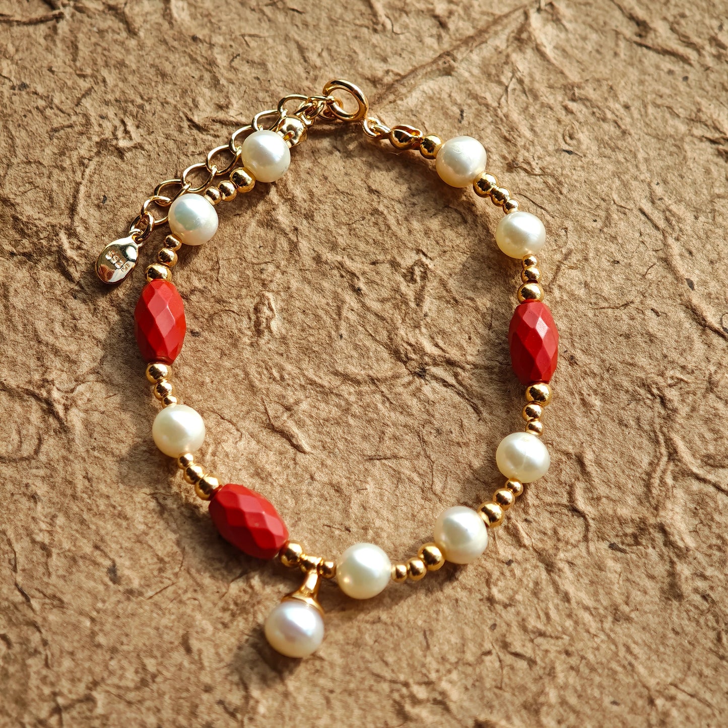This is a bracelet consist of genuine 925 silver, luminous 5-6mm freshwater pearls, and striking cinnabar. The bracelet measures 16cm with a 3cm extender.