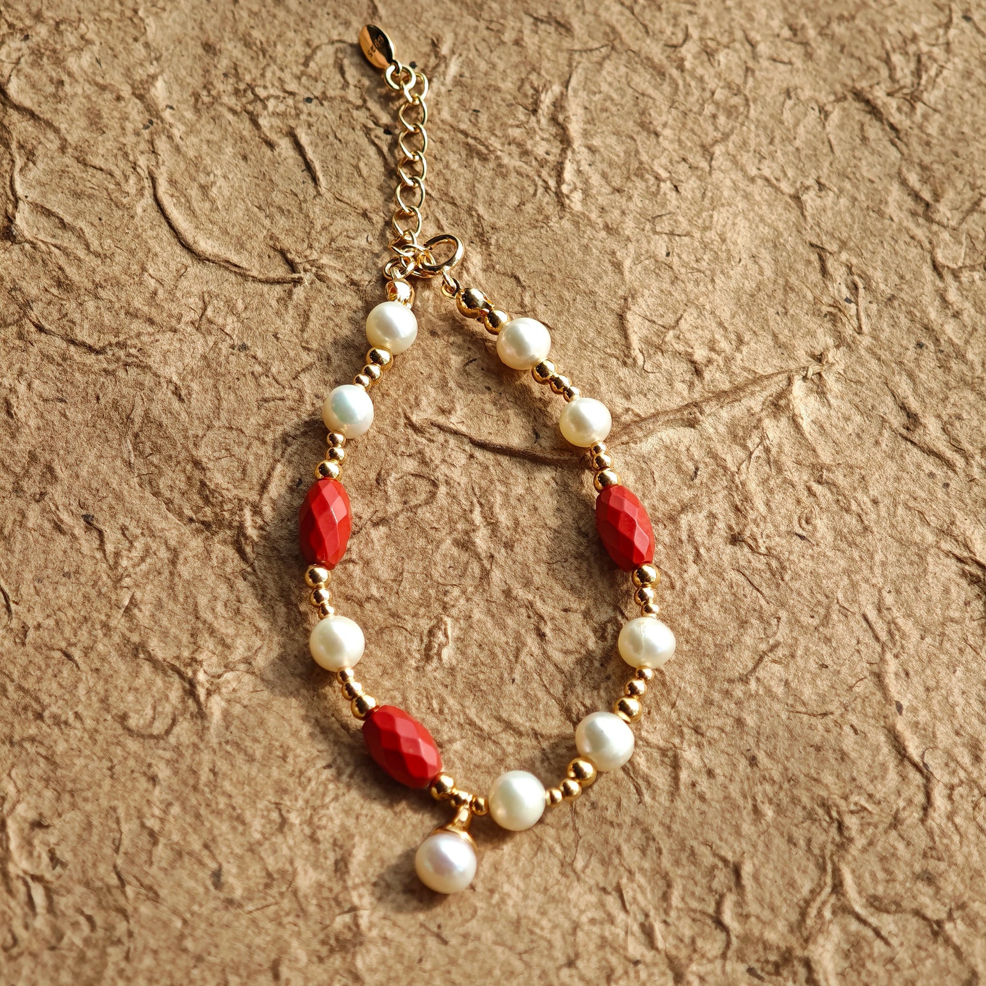 This is a bracelet consist of genuine 925 silver, luminous 5-6mm freshwater pearls, and striking cinnabar. The bracelet measures 16cm with a 3cm extender.