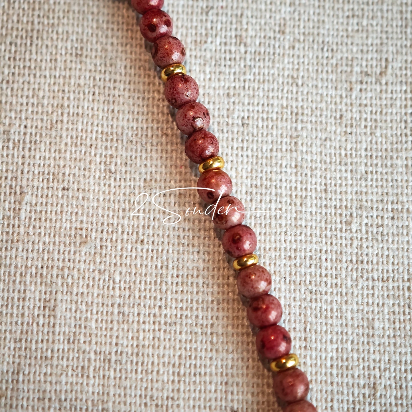 This is a bracelet that made of Czech beads. And it's highlighted by blue, purple, and black flower charms and green leaf accents, creating a stunningly attractive design.