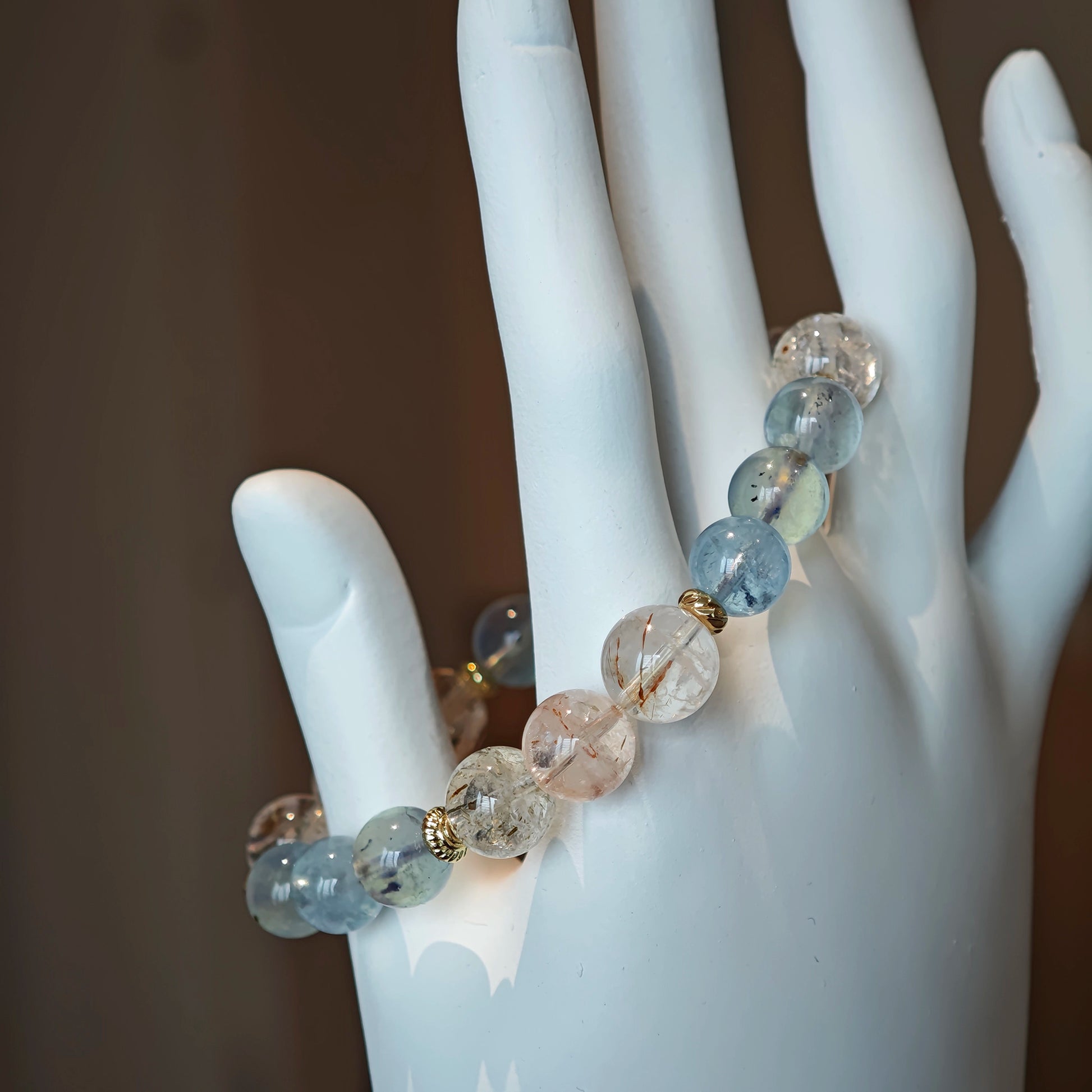 Aquamarine beads swirl beside rutile’s golden rays, tied together by refined gold spacers.