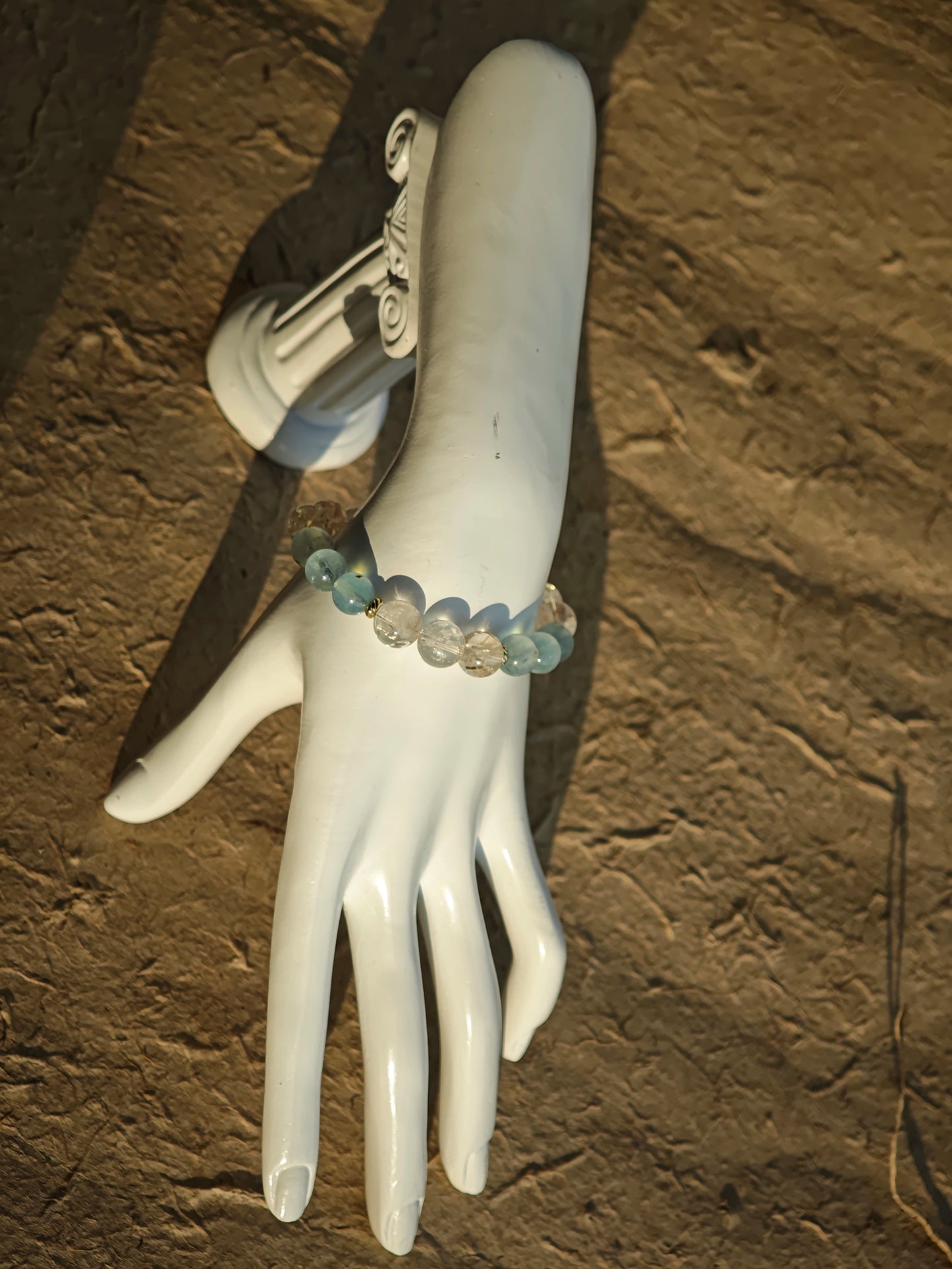 From aquamarine depths to rutile flashes, gold accents complete the coastal scene.