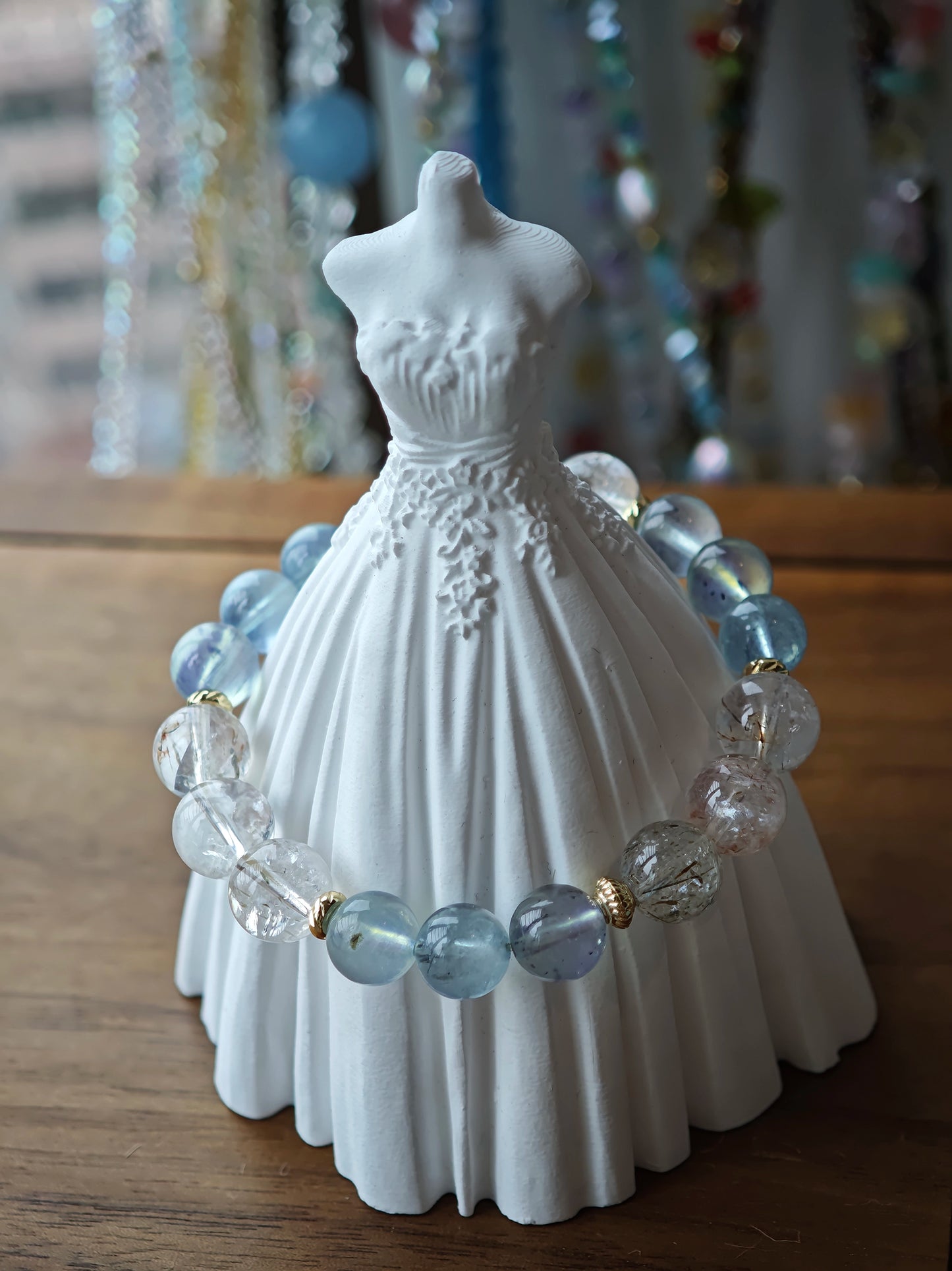 Shimmering sea hues and sunlit rutile crystals alternate, wrapped in graceful gold.