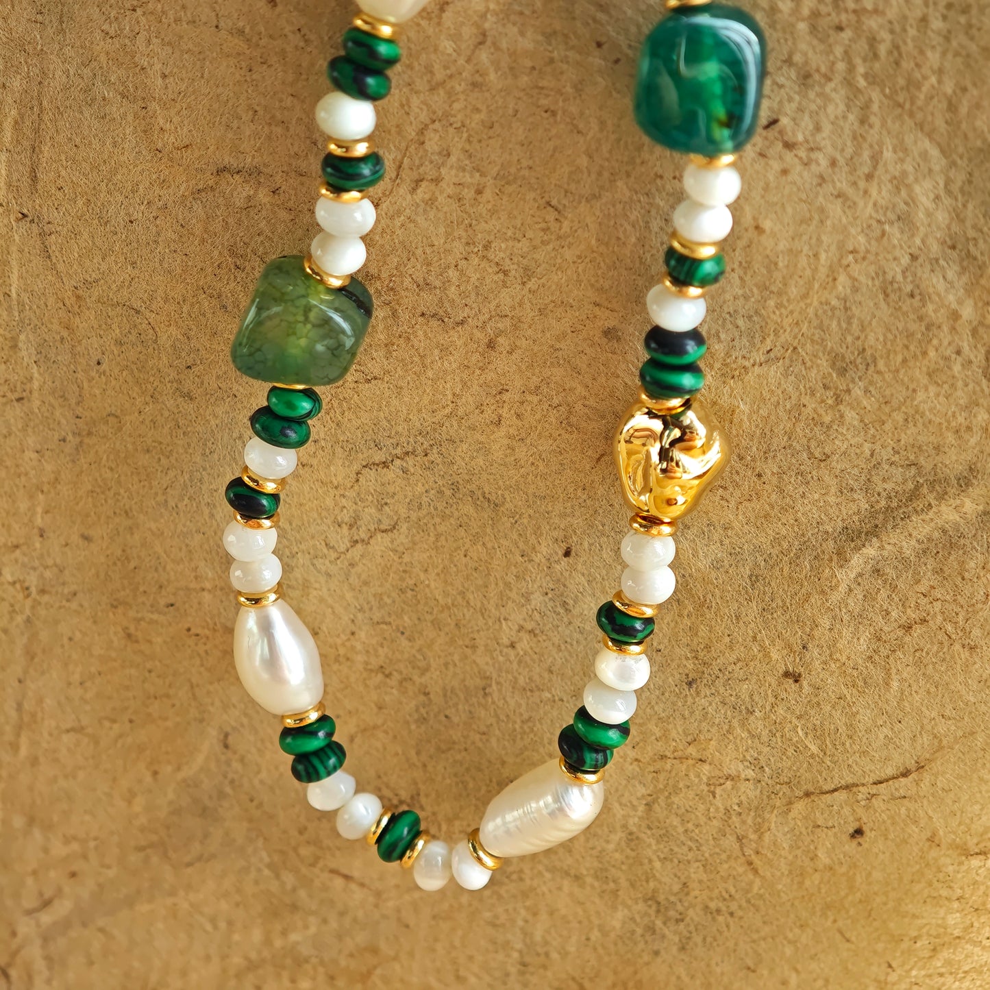 This is a necklace consist of 925 sterling silver with a vintage gold finish, featuring real pearls, malachite, and green agate. The chain is 36cm with a 7cm extender, ensuring it lays beautifully.