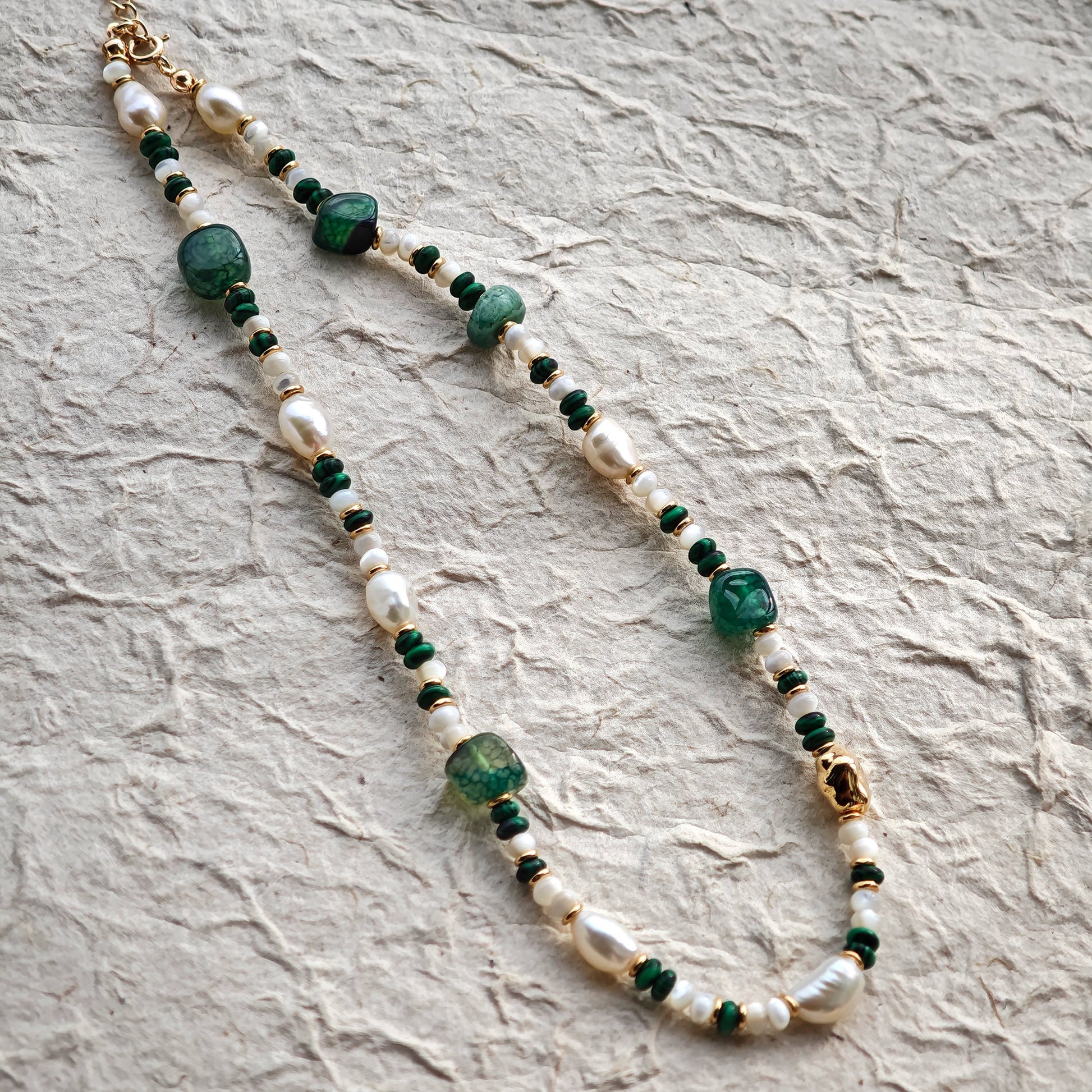 This is a necklace consist of 925 sterling silver with a vintage gold finish, featuring real pearls, malachite, and green agate. The chain is 36cm with a 7cm extender, ensuring it lays beautifully.