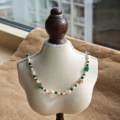 This is a necklace consist of 925 sterling silver with a vintage gold finish, featuring real pearls, malachite, and green agate. The chain is 36cm with a 7cm extender, ensuring it lays beautifully.
