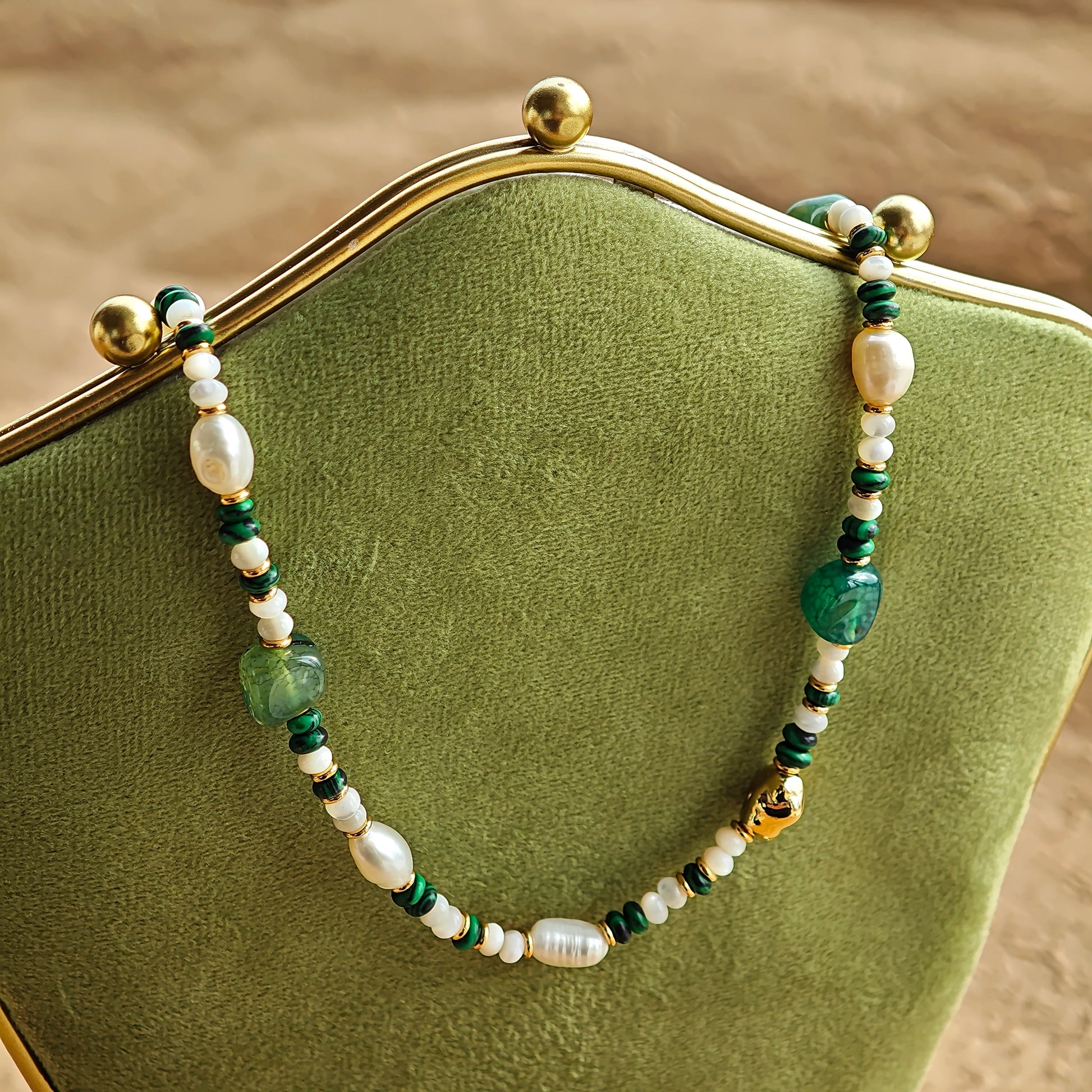 This is a necklace consist of 925 sterling silver with a vintage gold finish, featuring real pearls, malachite, and green agate. The chain is 36cm with a 7cm extender, ensuring it lays beautifully.