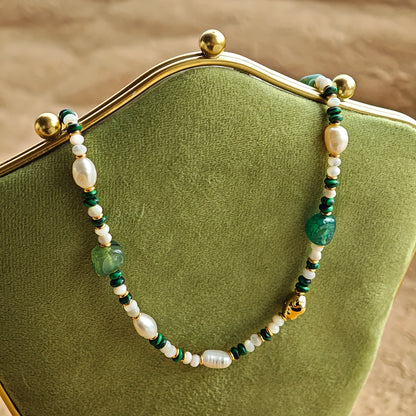 This is a necklace consist of 925 sterling silver with a vintage gold finish, featuring real pearls, malachite, and green agate. The chain is 36cm with a 7cm extender, ensuring it lays beautifully.