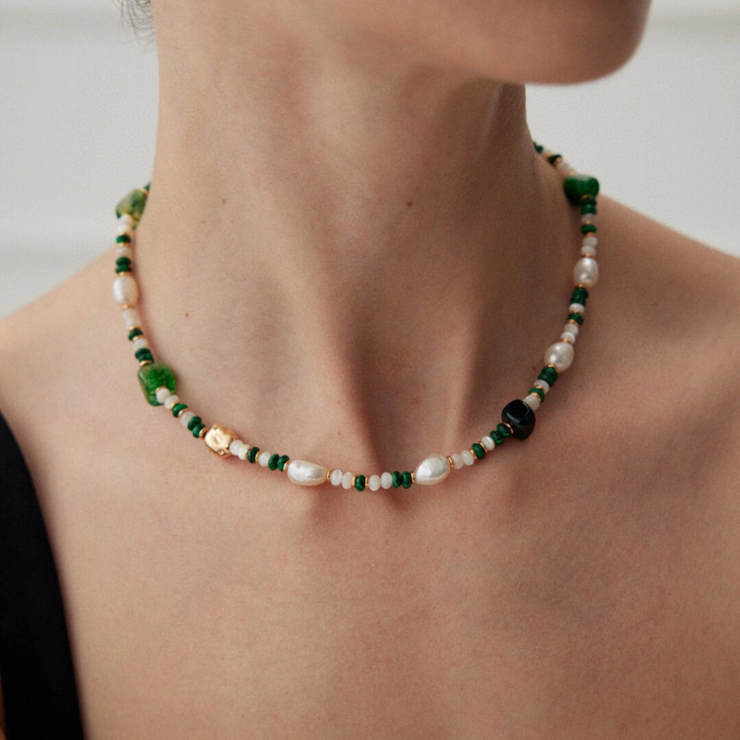 This is a necklace consist of 925 sterling silver with a vintage gold finish, featuring real pearls, malachite, and green agate. The chain is 36cm with a 7cm extender, ensuring it lays beautifully.