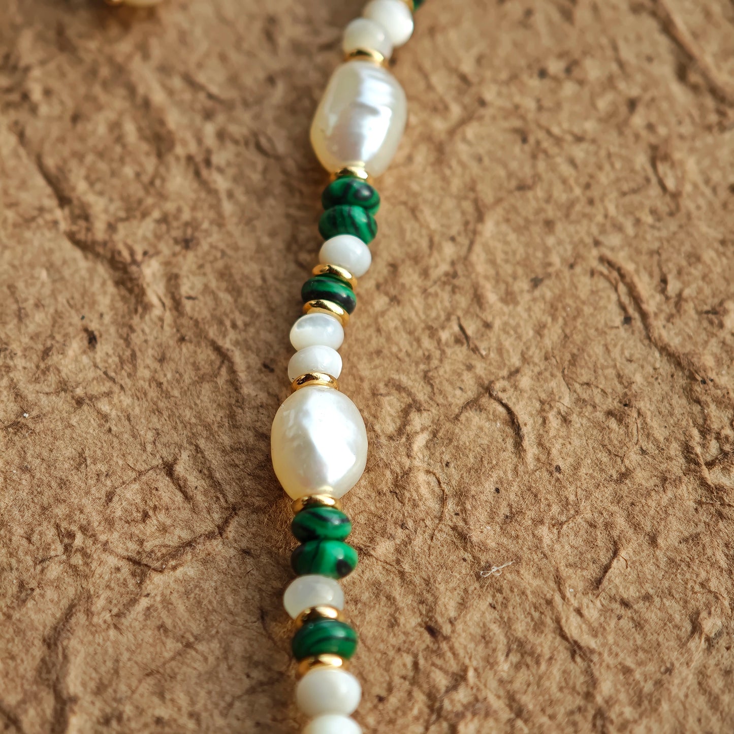 This is a necklace consist of 925 sterling silver with a vintage gold finish, featuring real pearls, malachite, and green agate. The chain is 36cm with a 7cm extender, ensuring it lays beautifully.