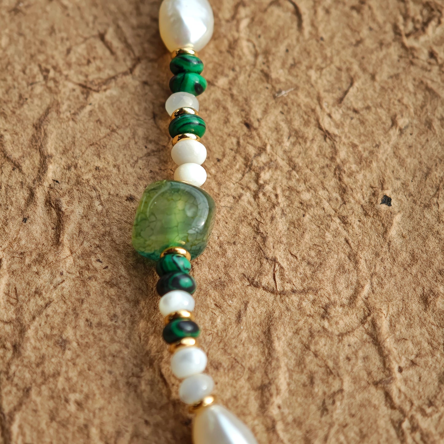 This is a necklace consist of 925 sterling silver with a vintage gold finish, featuring real pearls, malachite, and green agate. The chain is 36cm with a 7cm extender, ensuring it lays beautifully.