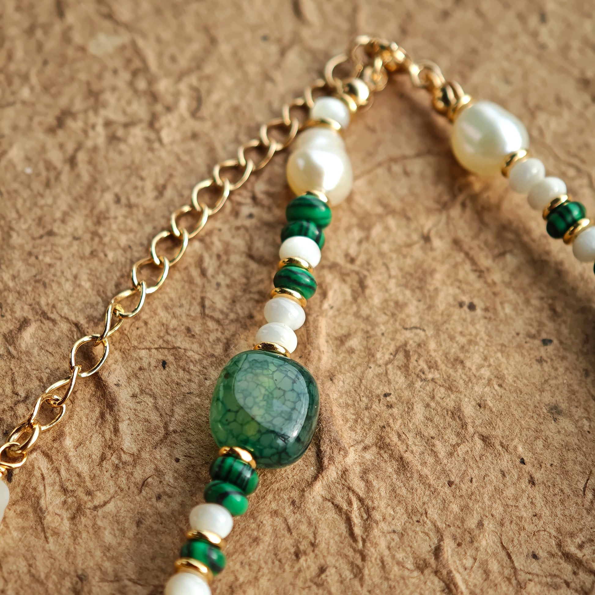 This is a necklace consist of 925 sterling silver with a vintage gold finish, featuring real pearls, malachite, and green agate. The chain is 36cm with a 7cm extender, ensuring it lays beautifully.