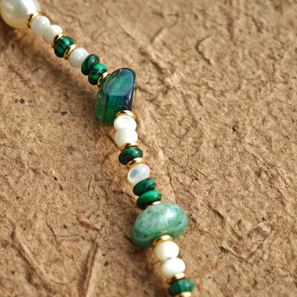 This is a necklace consist of 925 sterling silver with a vintage gold finish, featuring real pearls, malachite, and green agate. The chain is 36cm with a 7cm extender, ensuring it lays beautifully.
