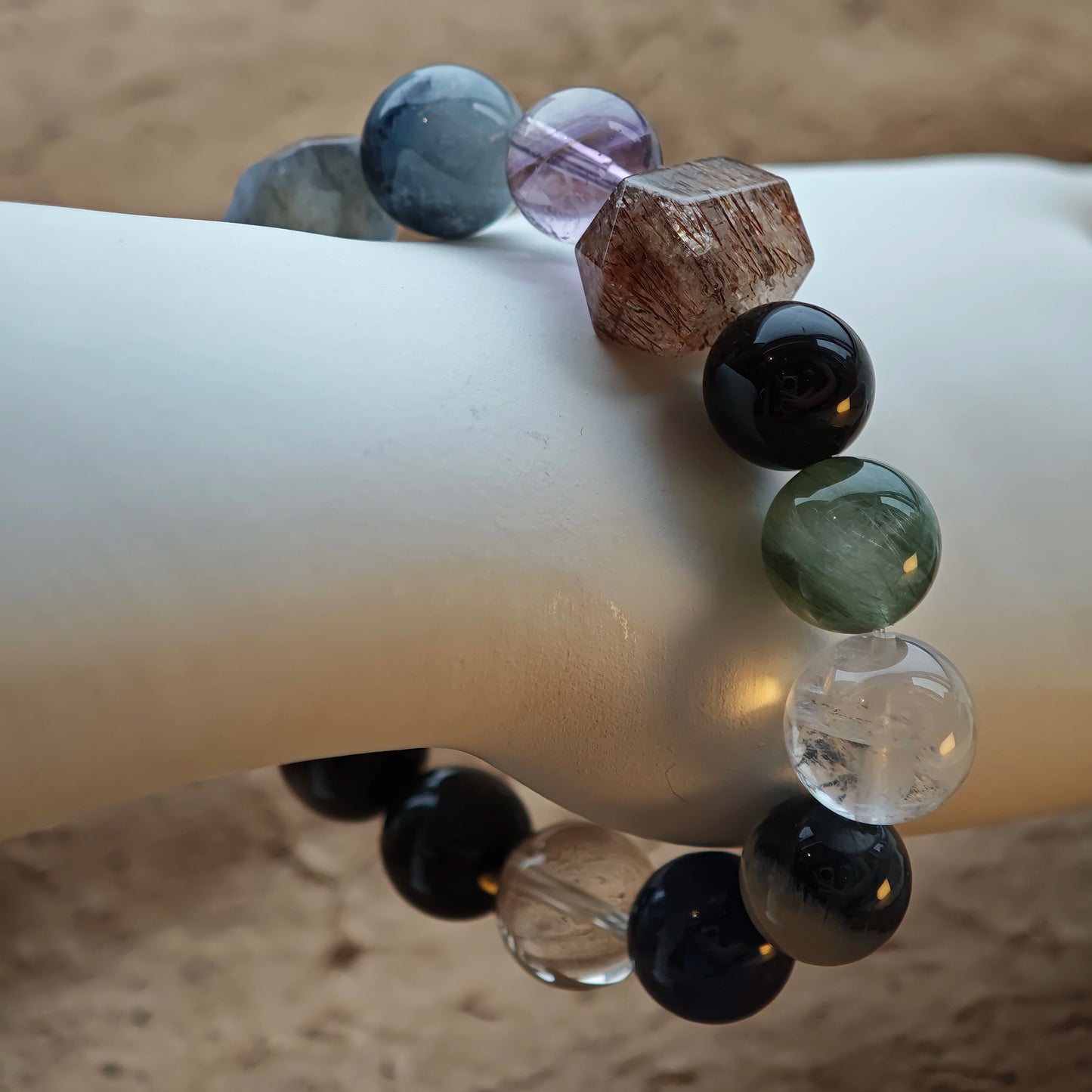 A hushed galaxy of stones: Black Gold Super Seven, Herkimer diamonds, clear quartz, sandalwood, amethyst, silver obsidian, white phantom quartz, and kyanite.