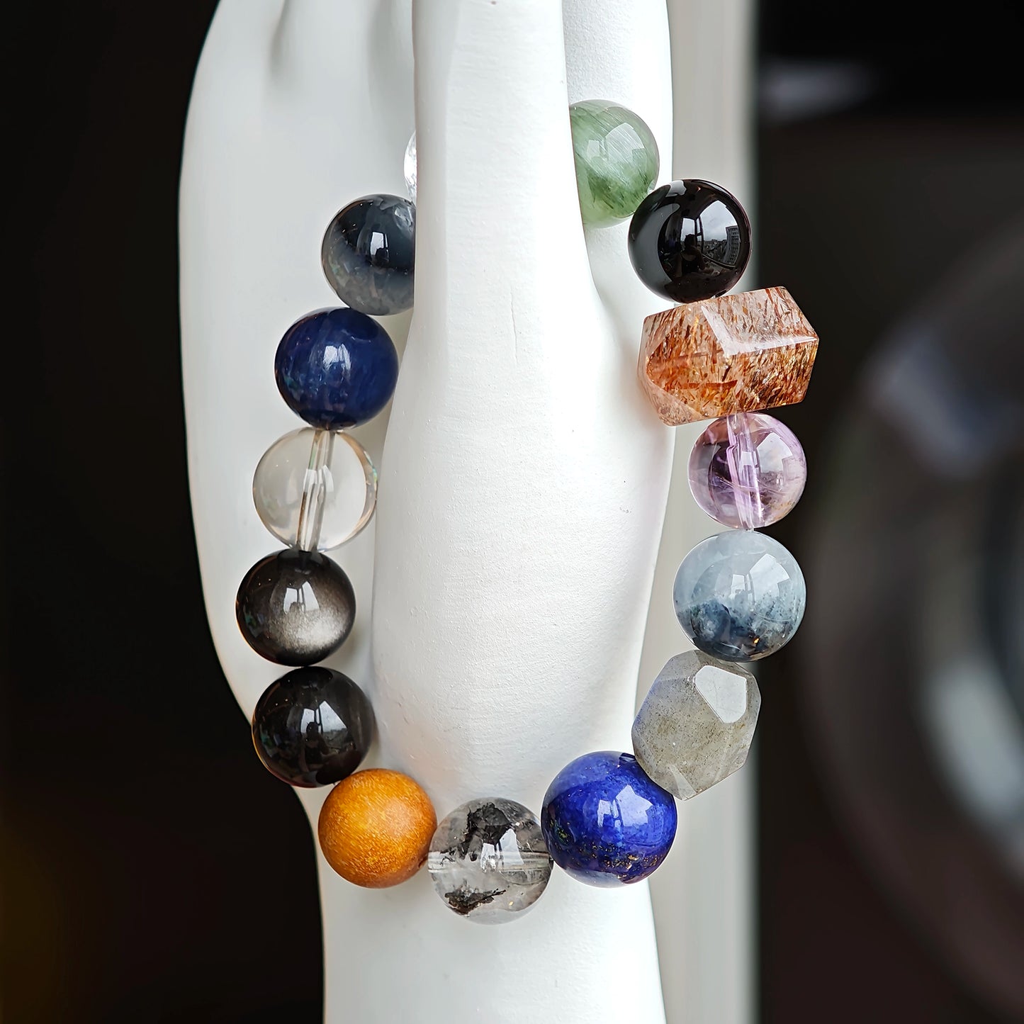 Quietly powerful, this strand unites Black Gold Super Seven, Herkimer diamonds, clear quartz, sandalwood, amethyst, silver obsidian, white phantom, and kyanite in slate and steel hues.