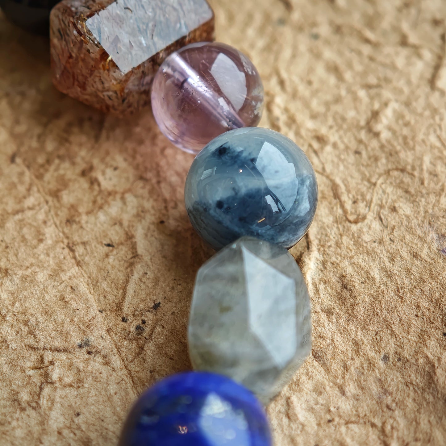Midnight tides and silver mists mingle in a bracelet of Black Gold Super Seven, Herkimer diamonds, clear quartz, sandalwood, amethyst, silver obsidian, white phantom quartz, and kyanite.