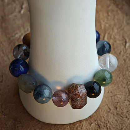 Cool mystic tones flow through Black Gold Super Seven, Herkimer diamonds, clear quartz, sandalwood, amethyst, silver obsidian, white phantom, and kyanite.