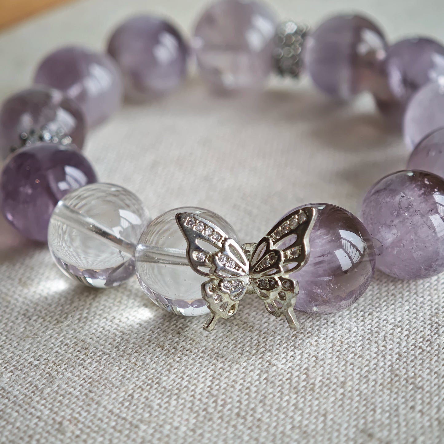 This is an artisan Purple Rabbit Hair Crystal Healing Bracelet, which is handmade with Lavender Amethyst, Clear Quartz & Butterfly Charm.