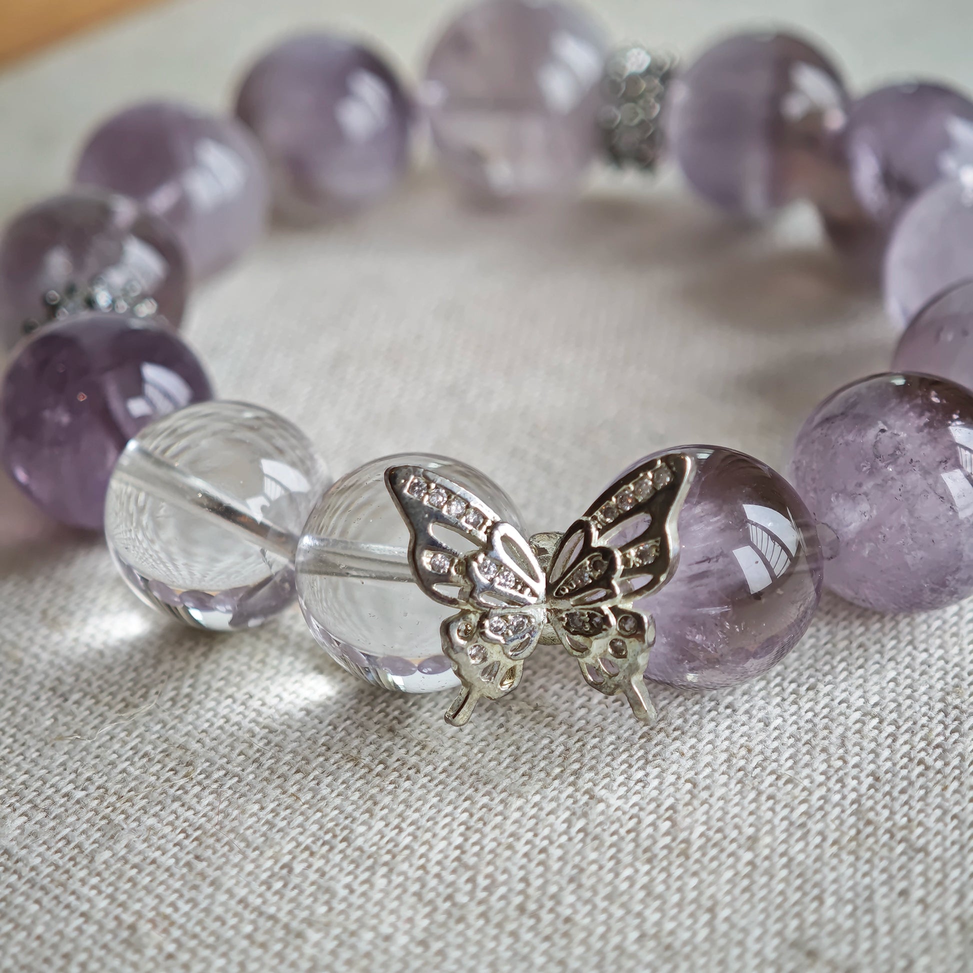 This is an artisan Purple Rabbit Hair Crystal Healing Bracelet, which is handmade with Lavender Amethyst, Clear Quartz & Butterfly Charm.