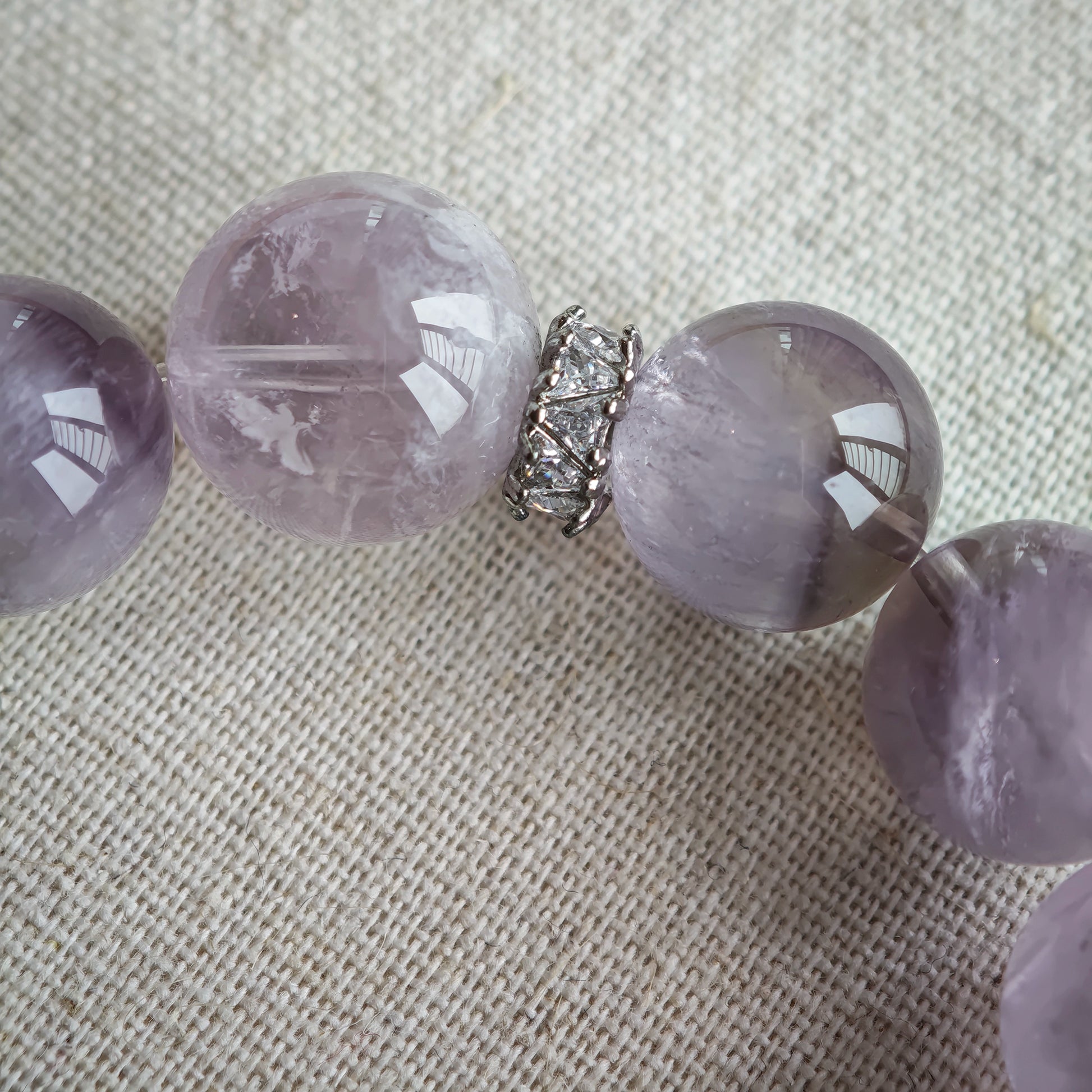 This is an artisan Purple Rabbit Hair Crystal Healing Bracelet, which is handmade with Lavender Amethyst, Clear Quartz & Butterfly Charm.