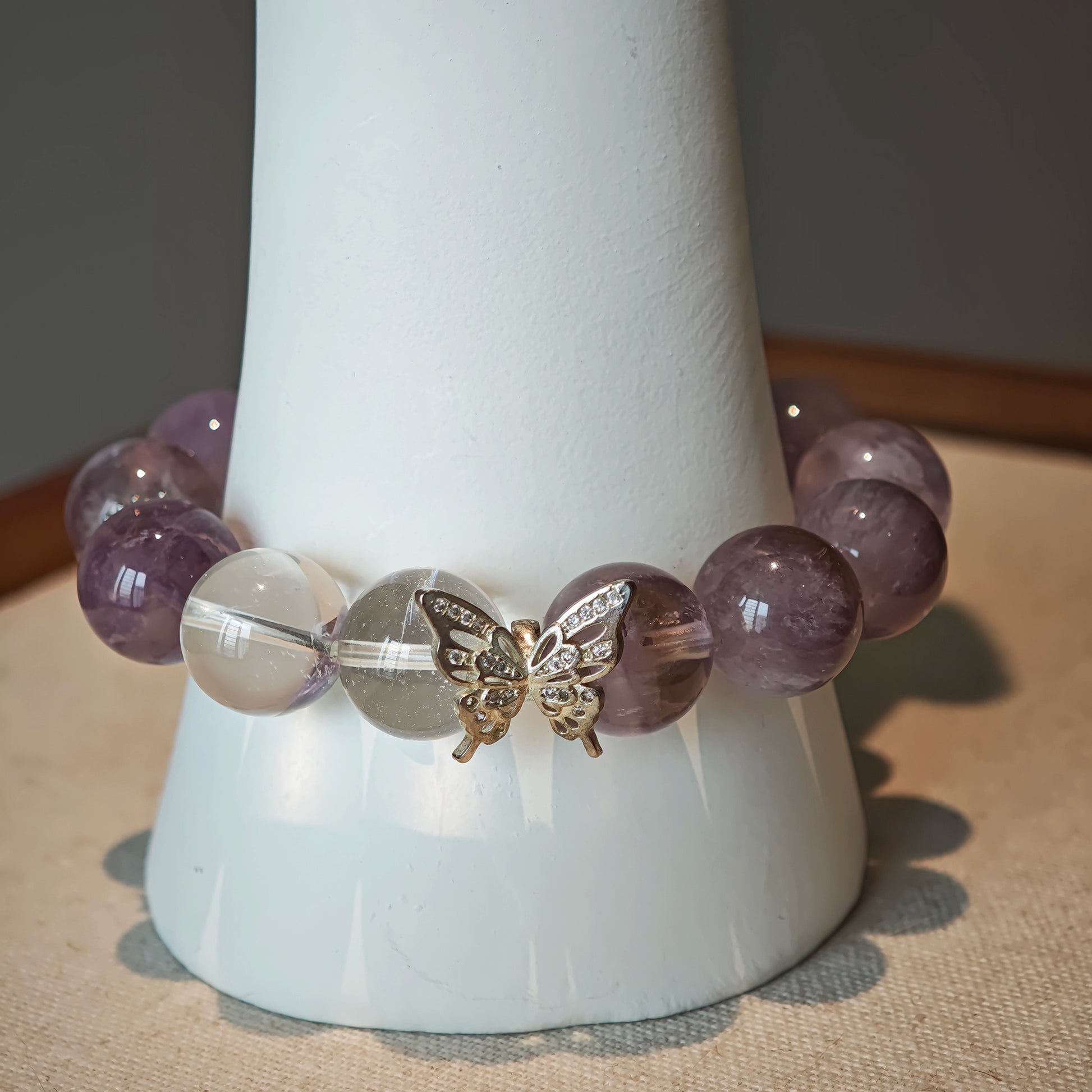 This is an artisan Purple Rabbit Hair Crystal Healing Bracelet, which is handmade with Lavender Amethyst, Clear Quartz & Butterfly Charm.