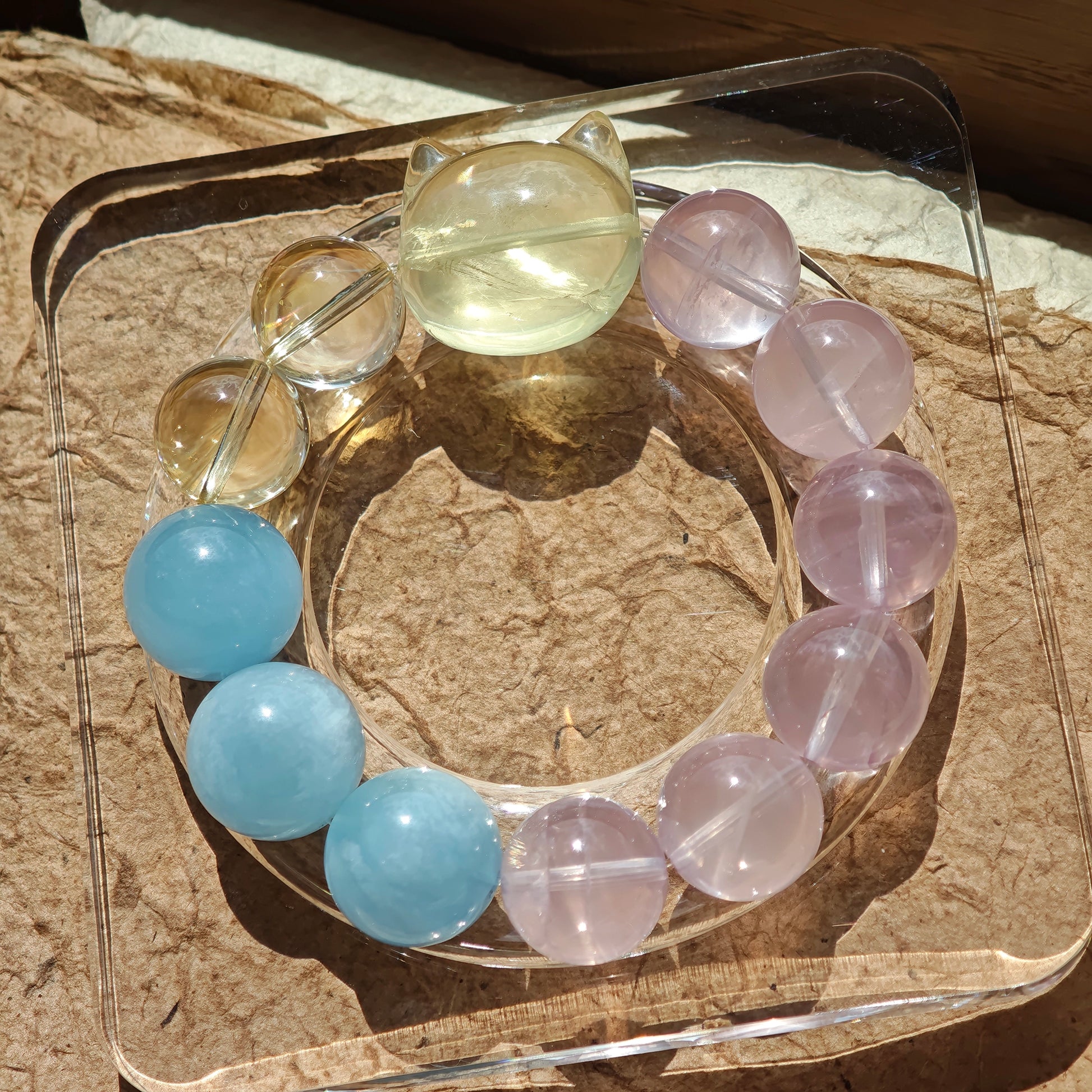 This is a Rose Quartz Bracelet with Aquamarine, Citrine crystal and cat charm.