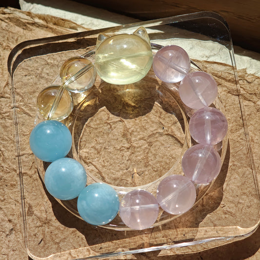 This is a Rose Quartz Bracelet with Aquamarine, Citrine crystal and cat charm.