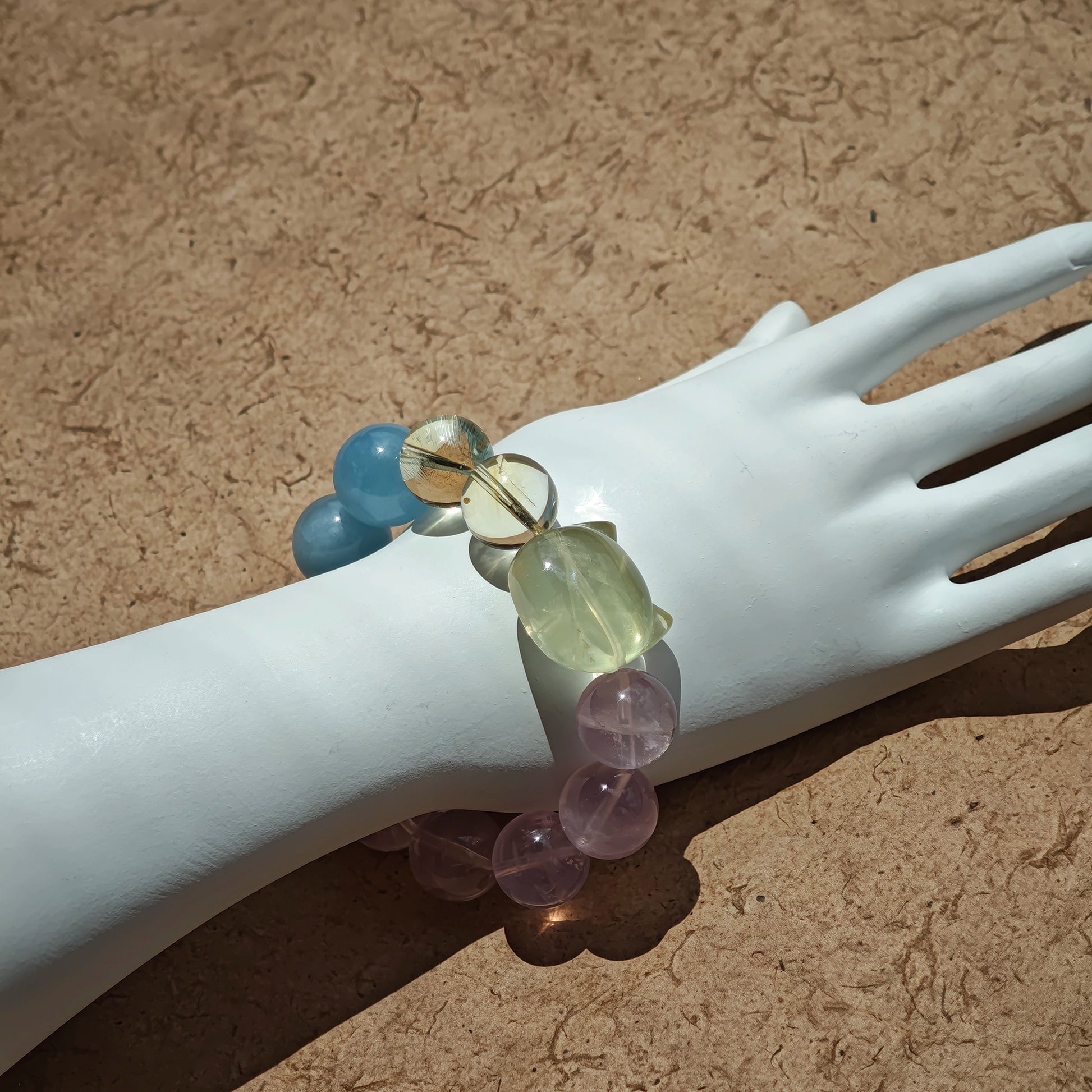 This is a Rose Quartz Bracelet with Aquamarine, Citrine crystal and cat charm.