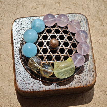 This is a Rose Quartz Bracelet with Aquamarine, Citrine crystal and cat charm.