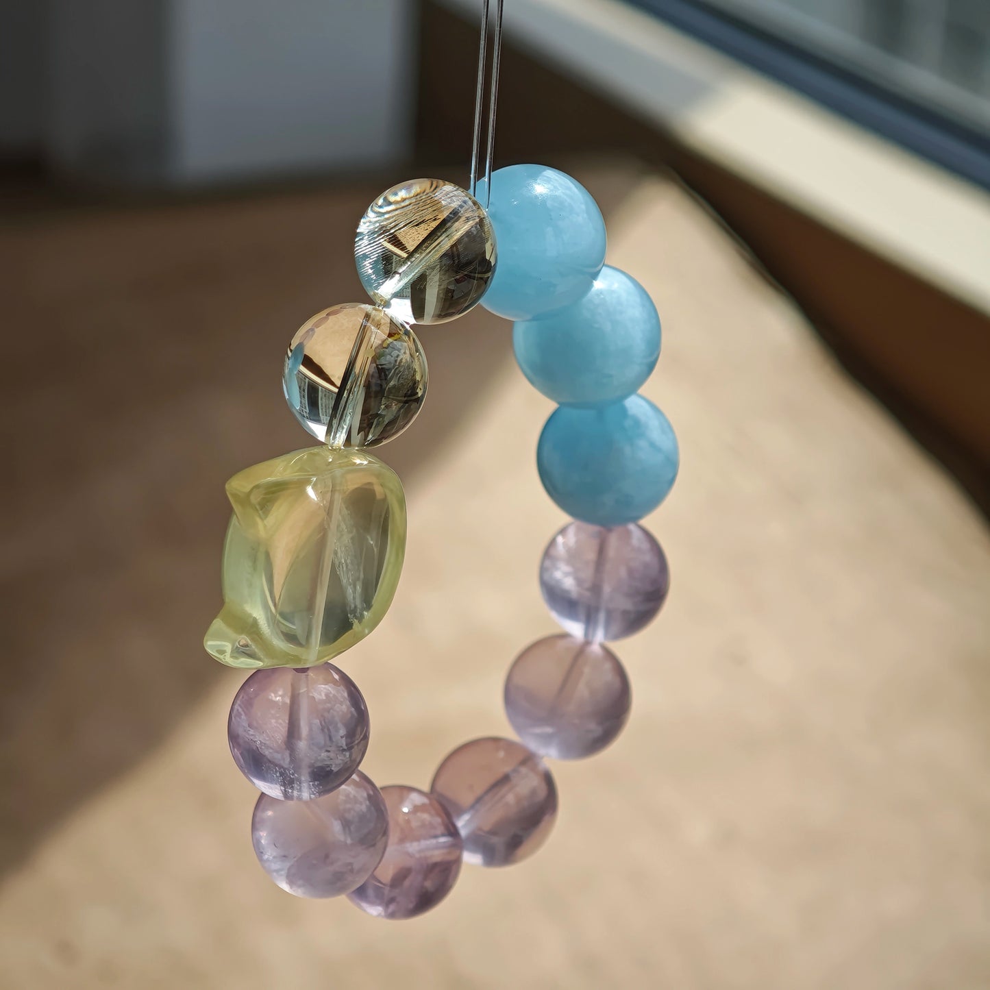 This is a Rose Quartz Bracelet with Aquamarine, Citrine crystal and cat charm.