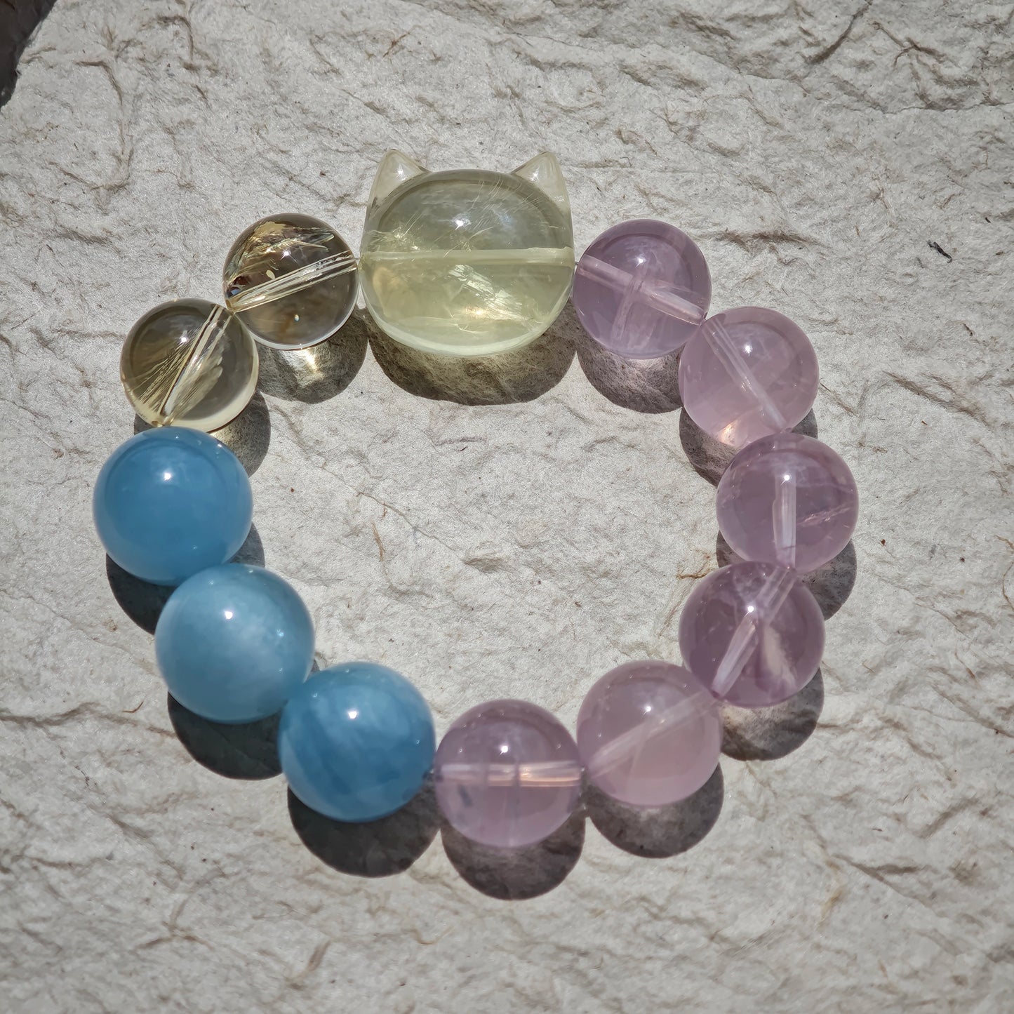 This is a Rose Quartz Bracelet with Aquamarine, Citrine crystal and cat charm.