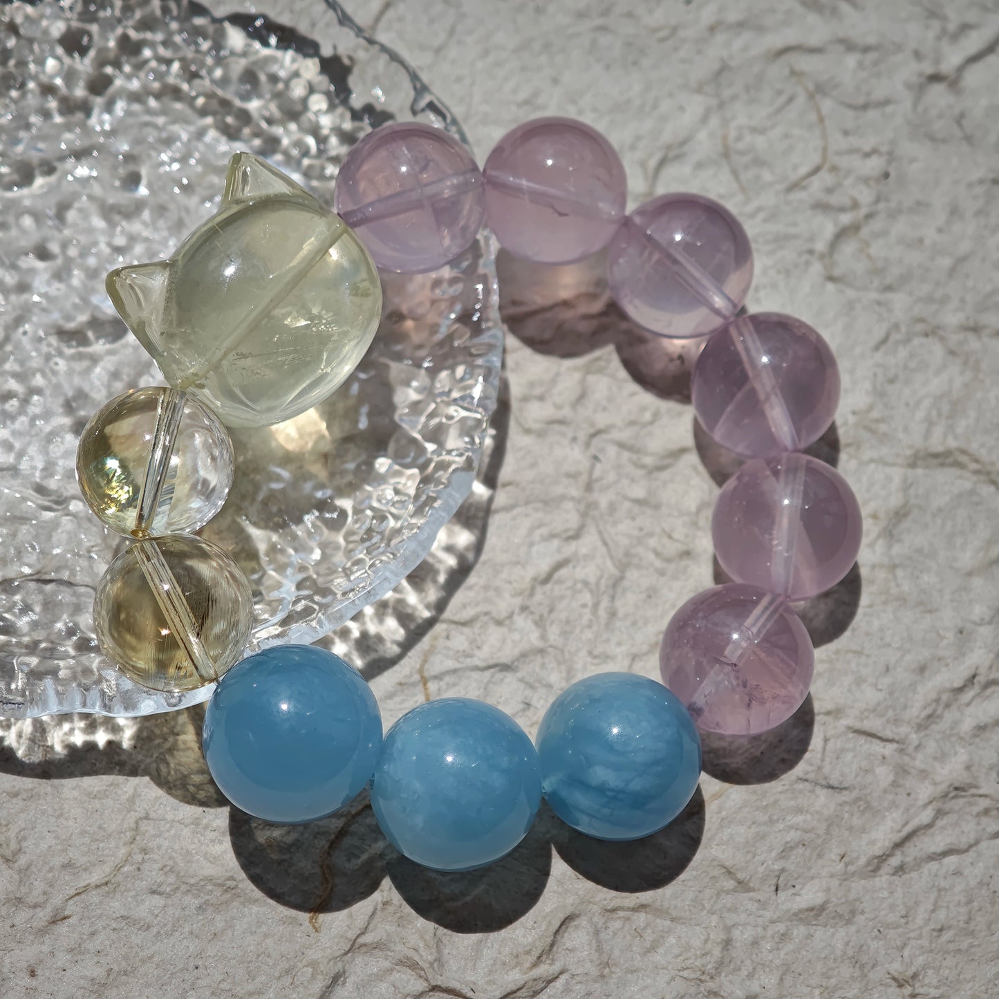 This is a Rose Quartz Bracelet with Aquamarine, Citrine crystal and cat charm.