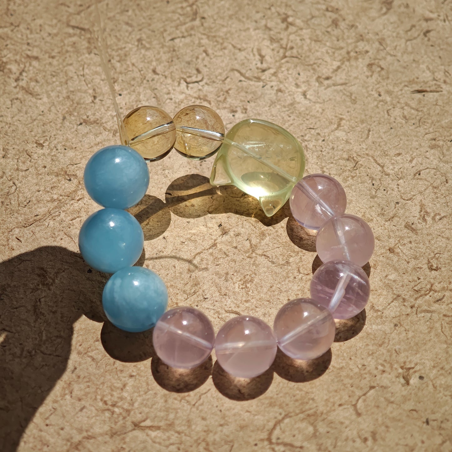 This is a Rose Quartz Bracelet with Aquamarine, Citrine crystal and cat charm.